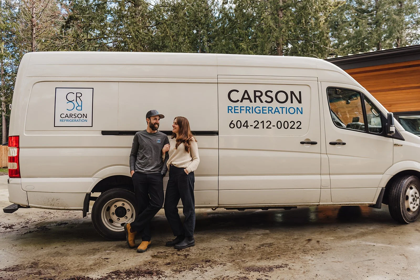 A Carson Heating & Cooling van and crew member on a Sunshine Coast job site